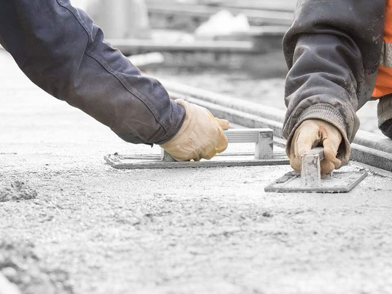 Contractor smoothing and finishing fresh concrete, Tampa, FL